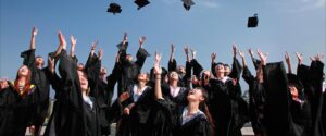 College graduates throwing hats in air