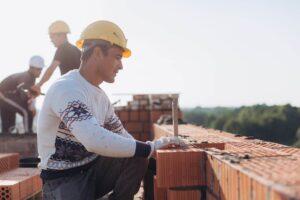 Construction worker placing bricks in place